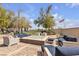 Inviting outdoor patio with comfortable seating and a cozy fire pit at 665 Look Lively Ct, Henderson, NV 89011