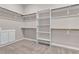 Spacious walk-in closet with custom shelving and ample storage space for organization of wardrobe and personal items at 665 Look Lively Ct, Henderson, NV 89011