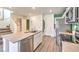 Bright kitchen features stainless appliances, gray countertops, and center island with undermount sink at 6954 Lynbridge St # Lot 56, Las Vegas, NV 89166