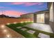 Backyard features an extended patio and artificial grass area at 70 Pikiariki Ct, Las Vegas, NV 89183