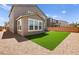 Backyard featuring artificial turf, gravel landscaping, and block wall provides a low maintenance outdoor space at 70 Pikiariki Ct, Las Vegas, NV 89183
