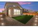 Well-maintained backyard with artificial turf, gravel, and stone patio, great for low-maintenance outdoor living at 70 Pikiariki Ct, Las Vegas, NV 89183