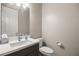 Well-lit half bathroom features a modern sink with elegant fixtures and tiled flooring at 70 Pikiariki Ct, Las Vegas, NV 89183