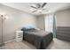 Neutral bedroom features a gray quilt, two side tables, and a ceiling fan for ultimate comfort at 70 Pikiariki Ct, Las Vegas, NV 89183