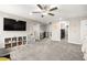 Spacious bonus room with neutral carpet, ceiling fan, ample space for play, and easy access to other rooms at 70 Pikiariki Ct, Las Vegas, NV 89183