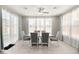 Bright dining room features large windows, elegant curtains, and a modern table with seating for six at 70 Pikiariki Ct, Las Vegas, NV 89183