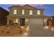 Inviting two-story home with a well-manicured front yard and a spacious two car garage at 70 Pikiariki Ct, Las Vegas, NV 89183