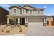 Well-manicured front yard and driveway leading to a two-story home with a two-car garage at 70 Pikiariki Ct, Las Vegas, NV 89183