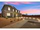 Striking home at dusk, showcasing manicured landscaping and a spacious driveway at 70 Pikiariki Ct, Las Vegas, NV 89183