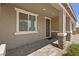 Inviting front porch with stone accents on the columns and a tiled entryway at 70 Pikiariki Ct, Las Vegas, NV 89183