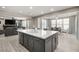 Open-concept kitchen boasts an oversized island, seamless flow to the dining and living spaces at 70 Pikiariki Ct, Las Vegas, NV 89183