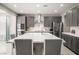 Gourmet kitchen features an oversized island, stainless steel appliances, and sleek gray cabinetry at 70 Pikiariki Ct, Las Vegas, NV 89183