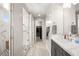 Modern main bathroom showcasing a glass shower, dual sinks, walk-in closet, and stylish fixtures at 70 Pikiariki Ct, Las Vegas, NV 89183
