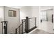 Carpeted staircase with dark wood and metal railing leading to an upstairs living space, enhancing home's modern appeal at 70 Pikiariki Ct, Las Vegas, NV 89183