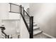 Staircase with carpeted steps and black metal railing leads to the second floor landing and bedrooms at 70 Pikiariki Ct, Las Vegas, NV 89183