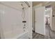 This bathroom features a shower and tub combination, and also a gray laminate floor at 702 Carlitos Ave, North Las Vegas, NV 89031