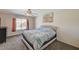 Cozy bedroom featuring a comfortable bed, soft carpet, and natural light from the window at 702 Carlitos Ave, North Las Vegas, NV 89031