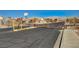 Gated community entrance ensures privacy and security, with desert landscaping and mountain views beyond the gate at 702 Carlitos Ave, North Las Vegas, NV 89031