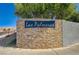 Las Palmeras community sign made of stone, set against desert backdrop, creating a sense of place and exclusivity at 702 Carlitos Ave, North Las Vegas, NV 89031