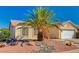 Charming single-story home featuring a well-maintained yard, with desert landscaping and an attached two-car garage at 702 Carlitos Ave, North Las Vegas, NV 89031