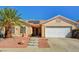 Charming single-story home featuring a well-maintained yard, tile roof, solar panels and an attached two-car garage at 702 Carlitos Ave, North Las Vegas, NV 89031