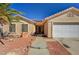 Charming single-story home featuring a well-maintained yard, tile roof, solar panels and an attached two-car garage at 702 Carlitos Ave, North Las Vegas, NV 89031
