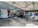 Spacious garage with ample storage, seating, and a workbench area at 702 Carlitos Ave, North Las Vegas, NV 89031
