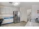 Bright kitchen featuring a stainless steel refrigerator and laundry area at 702 Carlitos Ave, North Las Vegas, NV 89031