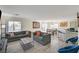 Bright living room with modern flooring, comfortable seating, and an open layout for entertaining and relaxing at 702 Carlitos Ave, North Las Vegas, NV 89031