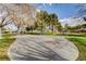 Serene park setting with trees, benches, and play areas, creating a peaceful environment for leisure and recreation at 702 Carlitos Ave, North Las Vegas, NV 89031