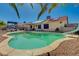 Backyard features a pristine in-ground pool and well-manicured landscaping, perfect for outdoor entertaining and relaxation at 702 Carlitos Ave, North Las Vegas, NV 89031
