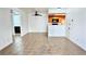 Bright living room features neutral tile flooring, and is adjacent to the kitchen with wood cabinets at 7100 Pirates Cove Rd # 1022, Las Vegas, NV 89145