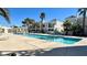Resort-style pool with lounge chairs, palm trees, and well-maintained landscaping at 7100 Pirates Cove Rd # 1022, Las Vegas, NV 89145