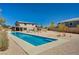 Large backyard showcasing a long, narrow swimming pool, desert landscaping, and the rear facade of the home at 7736 Tioga Ridge Ct, Las Vegas, NV 89117
