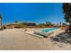 Backyard oasis featuring a pool, spa, desert landscaping, and clear blue skies at 7736 Tioga Ridge Ct, Las Vegas, NV 89117