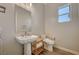 Bathroom with a pedestal sink, modern toilet, and wood-look flooring at 7736 Tioga Ridge Ct, Las Vegas, NV 89117
