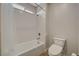 Well-lit bathroom featuring a shower over tub combination with white tile and chrome fixtures at 7736 Tioga Ridge Ct, Las Vegas, NV 89117