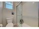 Modern bathroom featuring a toilet and a glass-enclosed shower with stylish tile at 7736 Tioga Ridge Ct, Las Vegas, NV 89117