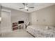 Comfortable bedroom with a ceiling fan, carpet, a desk, and soft natural light at 7736 Tioga Ridge Ct, Las Vegas, NV 89117