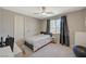 This bright bedroom includes neutral walls, ample natural light from a window, and comfortable carpet flooring at 7736 Tioga Ridge Ct, Las Vegas, NV 89117