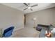 Bedroom featuring a ceiling fan, a large window, and space for a seating area and desk at 7736 Tioga Ridge Ct, Las Vegas, NV 89117