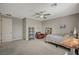 Comfortable bedroom featuring a ceiling fan, a large window, and neutral décor at 7736 Tioga Ridge Ct, Las Vegas, NV 89117