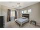Cozy bedroom features natural light, a comfortable bed, and neutral decor for a tranquil retreat at 7736 Tioga Ridge Ct, Las Vegas, NV 89117