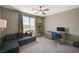 Bedroom featuring a ceiling fan, a large window, and space for a seating area and desk at 7736 Tioga Ridge Ct, Las Vegas, NV 89117