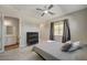 Comfortable bedroom with plush carpeting, ceiling fan and large window at 7736 Tioga Ridge Ct, Las Vegas, NV 89117