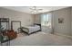 Comfortable bedroom featuring a ceiling fan, a large window, and neutral décor at 7736 Tioga Ridge Ct, Las Vegas, NV 89117