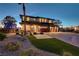 Beautiful two-story home with a manicured front yard and a three-car garage at 7736 Tioga Ridge Ct, Las Vegas, NV 89117