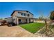 A two-story home boasts a covered patio and artificial turf lawn at 7736 Tioga Ridge Ct, Las Vegas, NV 89117
