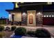 Inviting front entryway featuring stone accents and a stylish red-framed door at 7736 Tioga Ridge Ct, Las Vegas, NV 89117