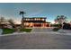 Stunning two-story home with a three-car garage, stone accents, and lush landscaping at 7736 Tioga Ridge Ct, Las Vegas, NV 89117